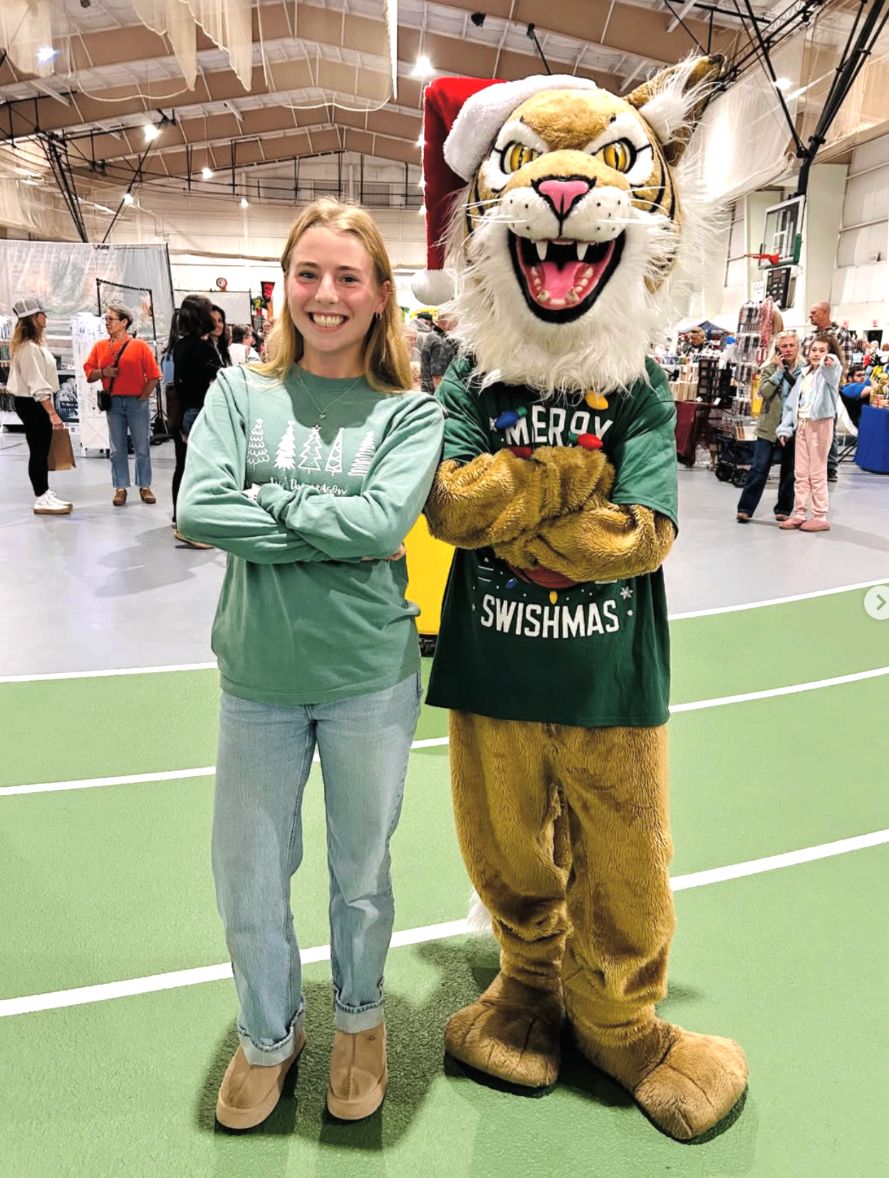 Madison with the Merry Swishmas mascot at a holiday market